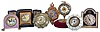 Clocks- 7 (Seven): including two "Lux" parasol novelties, a German alarm with lavender enamel and decorated dial, a miniature cartel style, a Zenith travel alarm with case, a British United novelty with velvet lined base, and a Seth Thomas