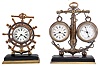 Clocks- 2 (Two): Both with nautical theme, the first signed "Lawson & Son Paris", brass trimmed, black slate base supporting a brass anchor encircled by rope, and with 8 day timepiece and barometer, both with white enamel dials, and rectangular plaque engraved "Vigilant", the other also with brass trimmed, black slate base supporting a brass anchor and 8 day timepiece with white enamel dial, the bezel with ships wheel surround, dimensions of larger piece listed