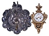 Clocks- 2 (Two): (1) a French cartel clock, ornate gilt case with foliate ornament, urn finial, and Green Man masks flanking the Roman numeral, white enamel dial, 8 day, time and strike, pendule de Paris movement; (2) Silvered, repousse "shield" front wall timepiece, decorated with c scrolls, and tippling vintner at top, Roman numeral dial, and cow tail pendulum, 8 day Japy Freres movement, dimensions of cartel listed