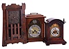 Clocks- 3 (Three) Mantel: (1) American, Mission oak shelf clock, 8 day time and strike, c1910; (2) Junghans, Germany, 8-day time & quarter strike bracket clock in a mahogany case, c1915; (3) German, modern bracket clock with floating balance movement in a walnut case, 1976.