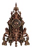 France, a large and imposing cast brass and bronze mantel clock, the base on tapered, scroll and cartouche ornamented feet, case front with niche containing a winged, half caryatid terminating in a foliate scroll, the sides with lions rampant guardant on pedestals, the top with bearded mask surrounded by foliate ornament and surmounted by an urn finial with flanking botanical pendants, Roman numeral dial with ornamental center, blued steel hands, 8 day, time and strike, pendule de Paris movement
