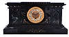 Boston Clock Co., Boston Mass., black mantel clock, 8 day, time and strike with single arbor tandem wind in a black slate case with green marble accents and fancy dial with raised cartouche numerals, c1895.
