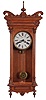 Waterbury Clock Co., Waterbury, Conn., "Kendall" wall hanging clock with a spring driven, 8 day time and half hour strike (cathedral gong) movement in an oak case.