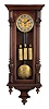 Clocks- 2 (Two): Both Vienna regulators, the first with veneered walnut case, ogee bottom bracket, door with applied half columns, arabic numeral silvered dial with sunk center, blued steel hands, and 8 day, quarter chiming, weight driven movement, the other with walnut veneered case, gadrooned bracket, door with applied half columns, and crest with carved and turned elements, Roman numeral white enamel dial, blued steel hands, and 8 day, time and strike, weight driven movement, dimensions of larger clock listed