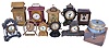 Clocks- 11 (Eleven) Novelty: Ansonia, "Stirrup" and clock with a miniature cathedral; one metal case and one plush clock by Waterbury; metal case clock depicting a roofed dwelling with balance wheel movement; novel electric clock that looks like a radio; ship's wheel clock advertising Gator Marine Oils; a black metal clock by Kroeber; small Jennings Brothers gilt brass clock with porcelain dial; Wedgewood case novelty clock; rotary mystery "tape measure" clock with original box and paper tag.