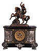 Ansonia Clock Co., New York, NY, "Dagobert" figural top ornament with a "Virginia" base shelf clock with a spring driven, 8 day, time and strike, (rack and snail) movement with visible escapement in a cast metal and enameled iron case.