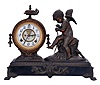 Ansonia Clock Co., New York, NY, "Eros" figure mantel clock with an 8 day spring driven time and half hour strike movement in a cast metal case with bronze plating.