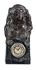 Junghans, Germany, "Monkey Business" novelty clock, 30 hour, time only spring driven movement in a cast metal case in the form of a monkey holding a book. A line runs up from the movement to the lower jaw and eyes, which are designed to move up and down slowly as the jaw opens and closes, c1920.