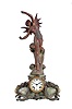 Ansonia Clock Co., New York, NY, "Superba base with La Vague top ornament" figural shelf clock with a spring driven, 8 day, time and strike movement in a cast metal case with Brazilian onyx panel inserts.