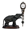 Junghans, Germany, "Elephant" model swinger, 8 day novelty timepiece, the patinated spelter elephant mounted to a molded beech base, his trunk supporting the compound pendulum with clock, Arabic numeral white enamel dial, blued steel hands, 8 day time only movement