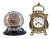 Clocks- 2 (Two) Desk Clocks: (1) France, desk compendium with aneroid barometer and two thermometers, 8 day, time and strike balance wheel movement in a Rococo revival brass case holding a polychrome enamel dial; (2) Majak, USSR, desk clock with balance wheel movement in a Mid-century Modern cut and polished crystal case held by two curved supports mounted to a black plastic base.