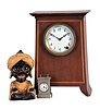 Clocks- 3 (Three) Desk and Novelty: (1) American Clock Co., Chicago, mantel clock, 8 day time only, spring driven movement in an inlaid mahogany case with white enamel dial showing Arabic numerals, c1930; (2) J. Oswald, Germany, "Sheik" rotating eye novelty clock of a seated figure with large earrings and turban with outstretched arms, c1950; (3) E.N. Welch, Forestville, Conn., "Little Corinne" miniature carriage clock, 30 hour time only movement in a nickel case with white enamel dial, c1889.