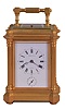 France, for Tiffany & Co., New York, hour repeating carriage clock with alarm, the glazed, the gilt, architectural case with projecting corners, fluted columns supporting a molded cornice, and a conforming, ovolo molded top with carrying handle, Roman numeral white enamel dial with subsidiary alarm chapter, blued steel Breguet style hands, and 8 day, time and strike movement with lever platform, striking the hour and half hour in passing, and repeating the last hour on demand, serial #3130, dial and movement signed