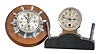 Clocks- 2 (Two) Chelsea: (1) Chelsea Clock Co., Boston, Mass., for Albert Dyke, New York, "Manhattan" instrument board clock, 8 day timepiece in a nickel case taking the form of a yacht wheel with 2.75 inch dial, serial number 573624, c1952. (2) Chelsea Clock Co., Boston, Mass., for Warner Instrument Co., Beloit, Wisconsin, 8 day, timepiece with a 2.75 inch dial, fitted to the top of a dark hardwood base inside of a brass case perhaps designed for an instrument panel or dashboard, serial number 38776, c1911.
