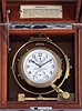 Hamilton Watch Co., Lancaster, Penn., model 22 chronometer watch with wind indicator, 35 size, 21 jewels, stem wind, pin set, adjusted to 6 positions and temperature, straight line damascened nickel plate movement, with lever escapement and micrometric regulator, Arabic numeral silvered metal dial, black steel spade and poker hands, the timepiece contained in a gimbaled bowl, and mounted in a mahogany box, movement marked "U.S. Navy Bu. Ships - 1942", serial #2F9086