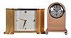 Clocks- 2 (Two): Both Chelsea, the first a "Doric" model, polished case on a molded base with ball feet, 2 1/2" silvered dial, signed "Theodore B. Starr Inc., New York", 8 day timepiece movement with lever escapement, serial #62988, the other a "Wisteria", gilt case with engraved decoration, silvered dial with Arabic numeral and dot markers, gilt dauphine hands, and 8 day timepiece movement with lever escapement, Wisteria dimensions listed
