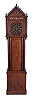 Germany, tall clock with 8 tune barrel organ, Gothic style softwood case, tall rectangular base below the trunk with fluted columns flanking the door, bonnet with decorative piercing, and stepped gable trim set with 15 turned finials, Roman numeral skeletonized dial with paper backing, brass, pierced spade hands, barrel organ playing eight tunes on twenty wooden pipes, cast iron weights, winding crank and brass pendulum ball