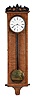 Vienna, Austria, 30 day hanging regulator in the Biedermeier style, rectilinear, 5 light, curly ash veneered case with mahogany stringing, incurved bottom bracket, and beveled projecting cornice, case top with applied, ebonized carving, Roman numeral white enamel dial, finely finished blued steel hands, month going timepiece movement, cylindrical brass weight, and pendulum with ebonized rod and brass ball