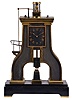 France, (Guilmet) industrial series "steam hammer", polished and patinated bronze case on a black slate base with polished feet, the hammer forming part of the complex pendulum, rising and falling, appearing to strike the anvil as the clock runs, Roman numeral metal dial, 8 day, time and strike pendule de Paris movement, with Guilmets modifications, and also with Guilmet's mark on the back plate