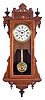 E. Ingraham & Co., Bristol, Conn., "Bartholdi" wall hanging clock with a spring driven, 8 day timepiece movement in a walnut case.