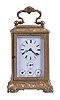 France, a mid 19th century striking carriage clock with alarm and semi perpetual calendar, the gilt, glazed case ornamented with trailing vines and leaves, the side panels of one piece construction with the glasses retained by inner frames, Roman numeral white enamel dial with subsidiary displays for the alarm, month, day, and date, blued steel trefoil hands, 8 day, time and strike movement with lever platform and calendar, with automatic correction for months with less than 31 days, sounding the hour and half hour in passing