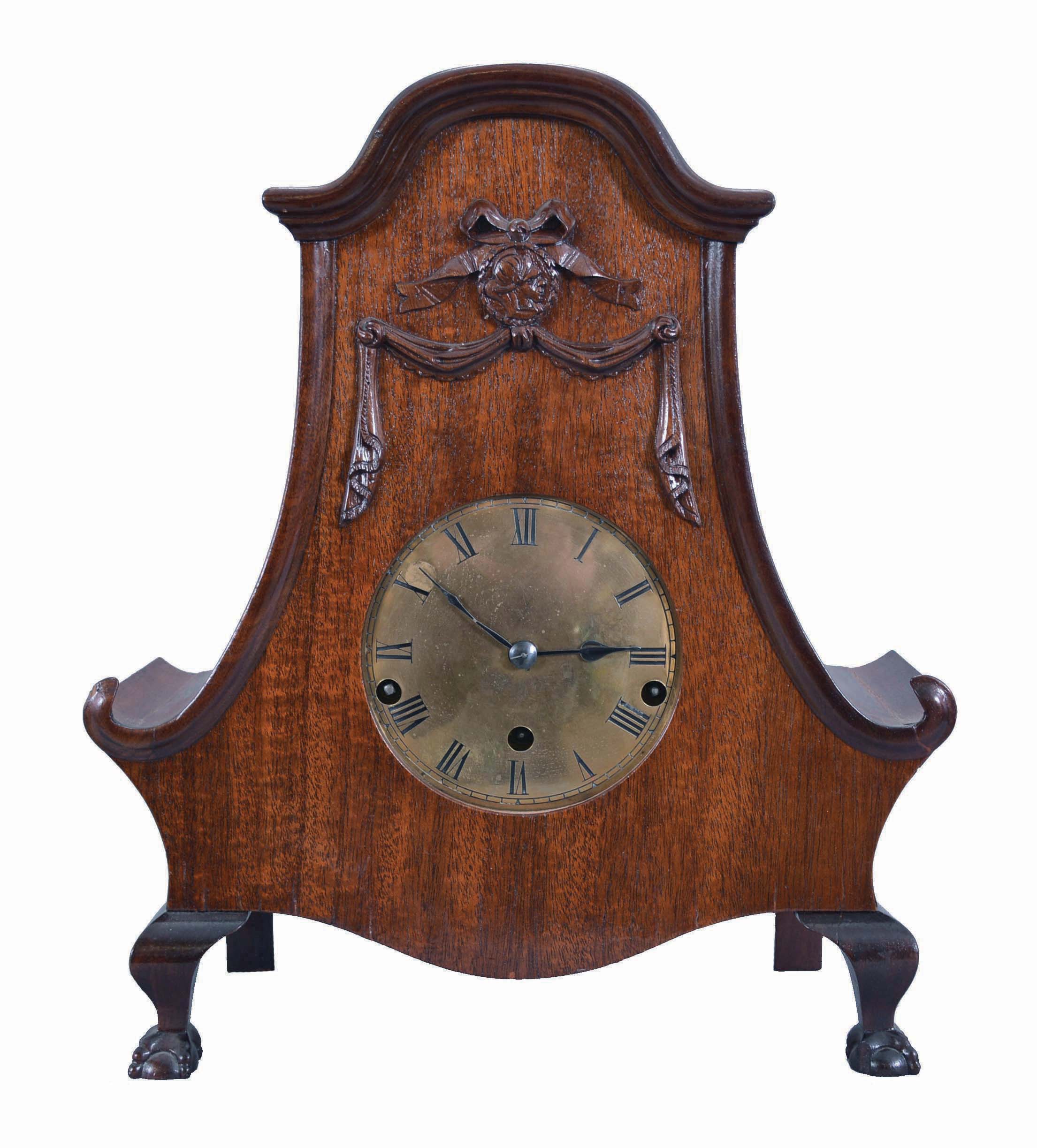 Clocks- 2 (Two) Wood and Brass: (1) Reproduction Clepsydra or water clock with cast brass crest and chapter ring, distressed wood pillars, woodworm holes in base, and rustic metalwork. The single hand is meant to move as water drips slowly from the cylindrical tank into the collection basin below; (2) Uhrenfabrik M,hlheim M,ller &amp; Co., Germany, mantel clock, 8 day, three-train Westminster chime, spring driven movement stamped with the lion and "U.M." trademark in a curved mahogany case with ball-and-claw front feet and brass dial. — Antique Clocks Price Guide