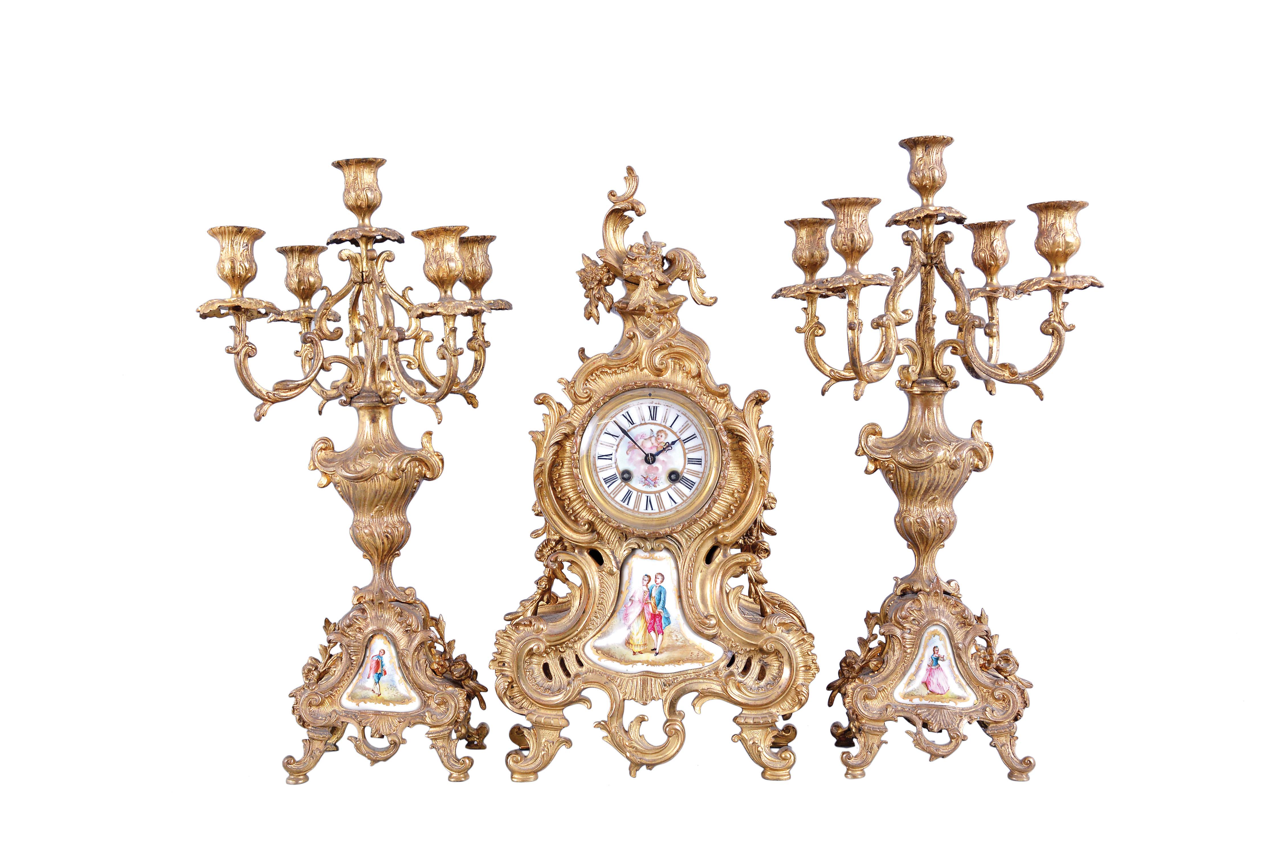 France, three piece mantel garniture, clock and matching candelabra on cast brass rococo bases with porcelain panels featuring polychrome figures and gilt borders, 8 day, time and strike, pendule de Paris movement by Japy Freres, counts the hours on gong. — Antique Clocks Price Guide