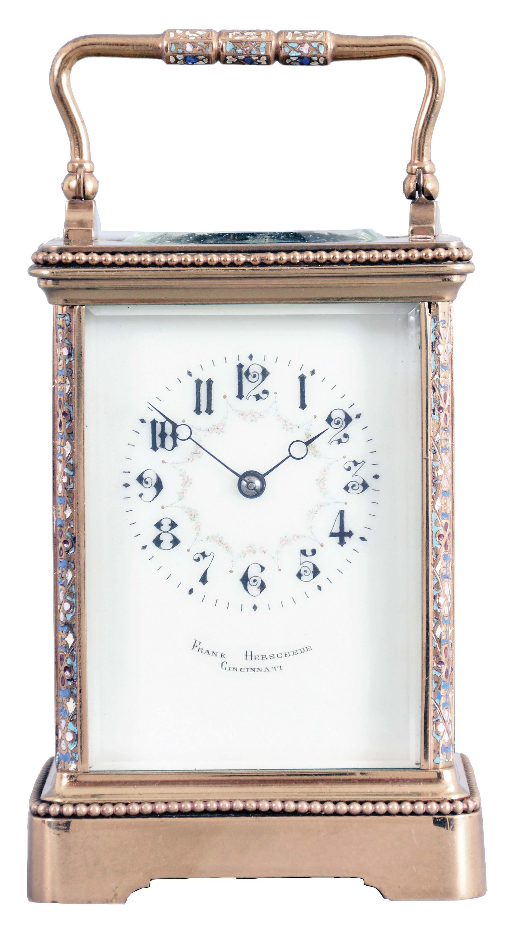France, for Frank Herschede, Cincinnati, an 8 day, two train carriage clock with champleve enamel ormnament, polished brass Corniche case with enamel accented corners and handle, Arabic numeral white enamel dial with floral featoons, blued steel Breguet style hands, 8 day, time and strike movement with lever platform, counting the hours on a gong — Antique Clocks Price Guide
