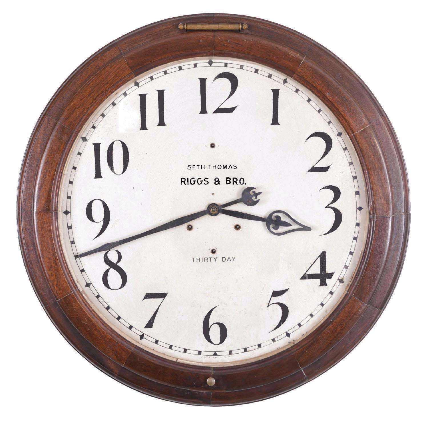 Seth Thomas Clock Co., Thomaston, Conn., "Arcade 24 Inch" wall timepiece, fitted with a large double spring thirty day movement, mahogany finish on mixed hardwood case, and with 24 inch dial, retailed by Riggs &amp; Bro, Philadelphia, and with the name RIGGS &amp; BRO. on dial. — Antique Clocks Price Guide