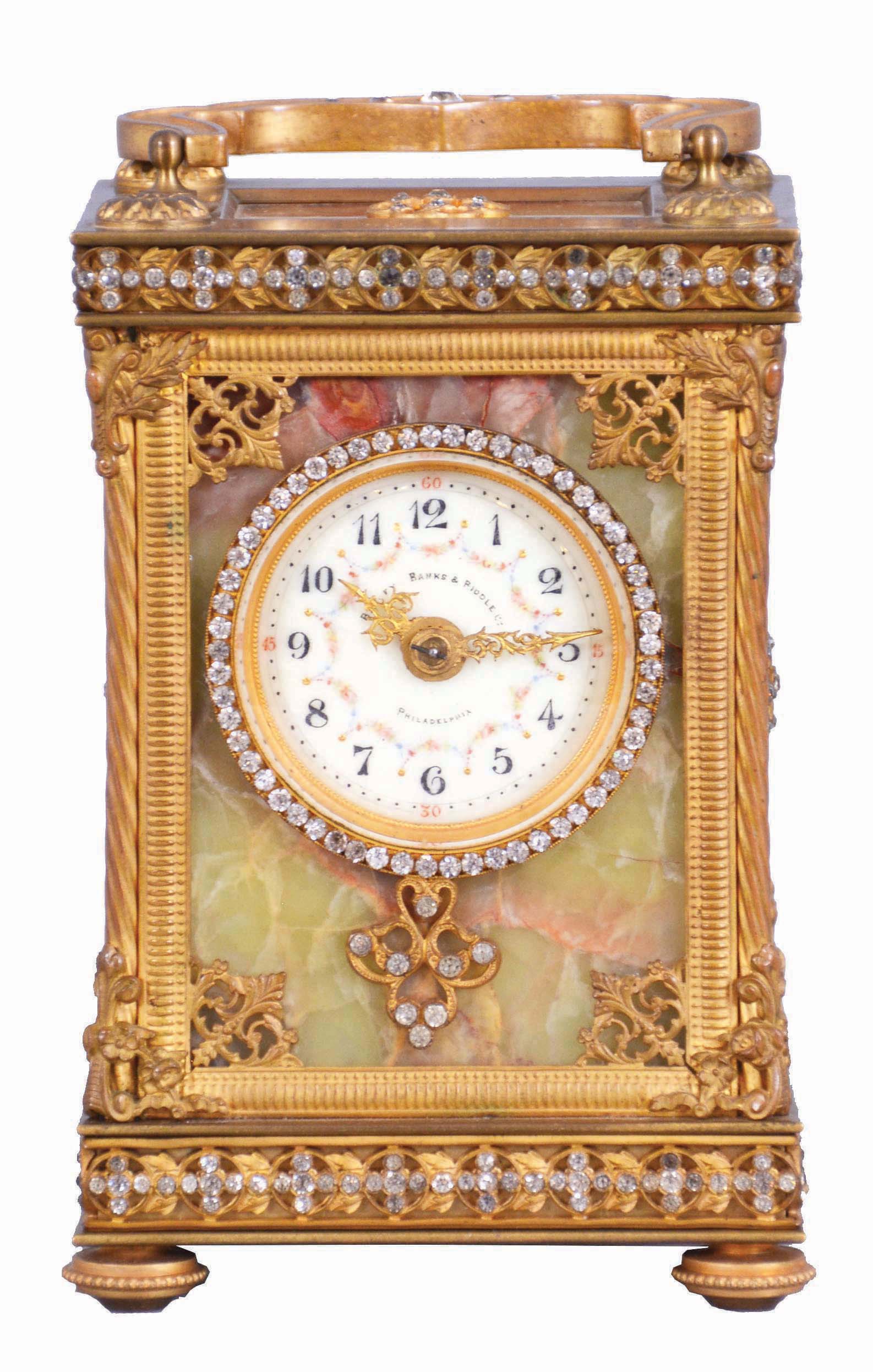 France, for Bailey, Banks &amp; Biddle Co., Philadelphia, a very decorative striking carriage clock with original travel case, the gilt case with green onyx panels, top and base with gilt fret, the frets, handle and bezel set with brilliants, Arabic numeral white enamel dial with polychrome enamel floral garlands, gilt Louis XV style hands, 8 day, time and strike movement with lever platform counting the hours in passing, together with its original leather covered travel case and key — Antique Clocks Price Guide
