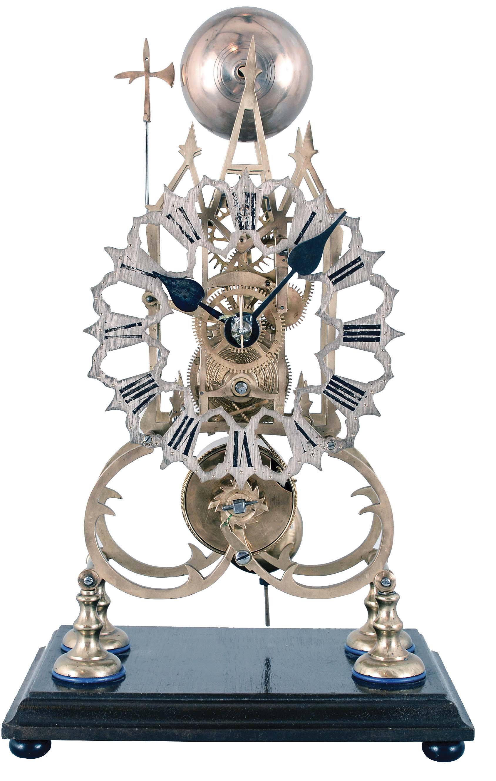 England, 3 spire Gothic frame, single fusee skeleton clock, with a silvered fretted dial, passing strike [single bell on the hour], no dome, mounted to a rectangular wooden base. — Antique Clocks Price Guide
