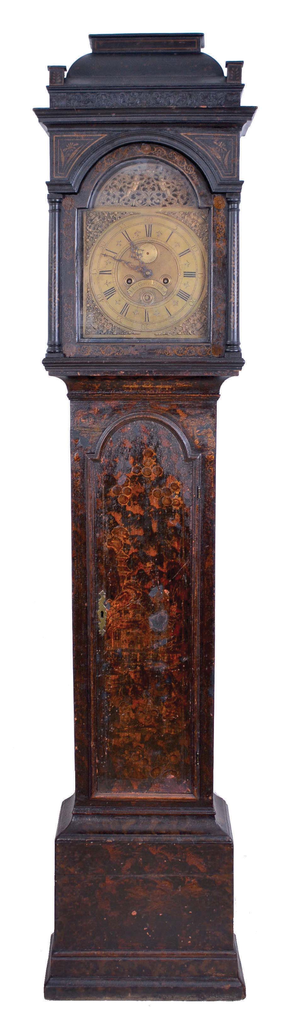John Green, Skipton, England tall clock, 8 day, time and gong strike, weight driven movement in a chinoiserie oak case with carved coffin top, three quarter columns on hood door and quarter columns on rear of hood on applied molded base. The brass dial has an applied reticulated arch with putti holding a crown, applied cast brass spandrels and calendar and maker's signature above 6. — Antique Clocks Price Guide