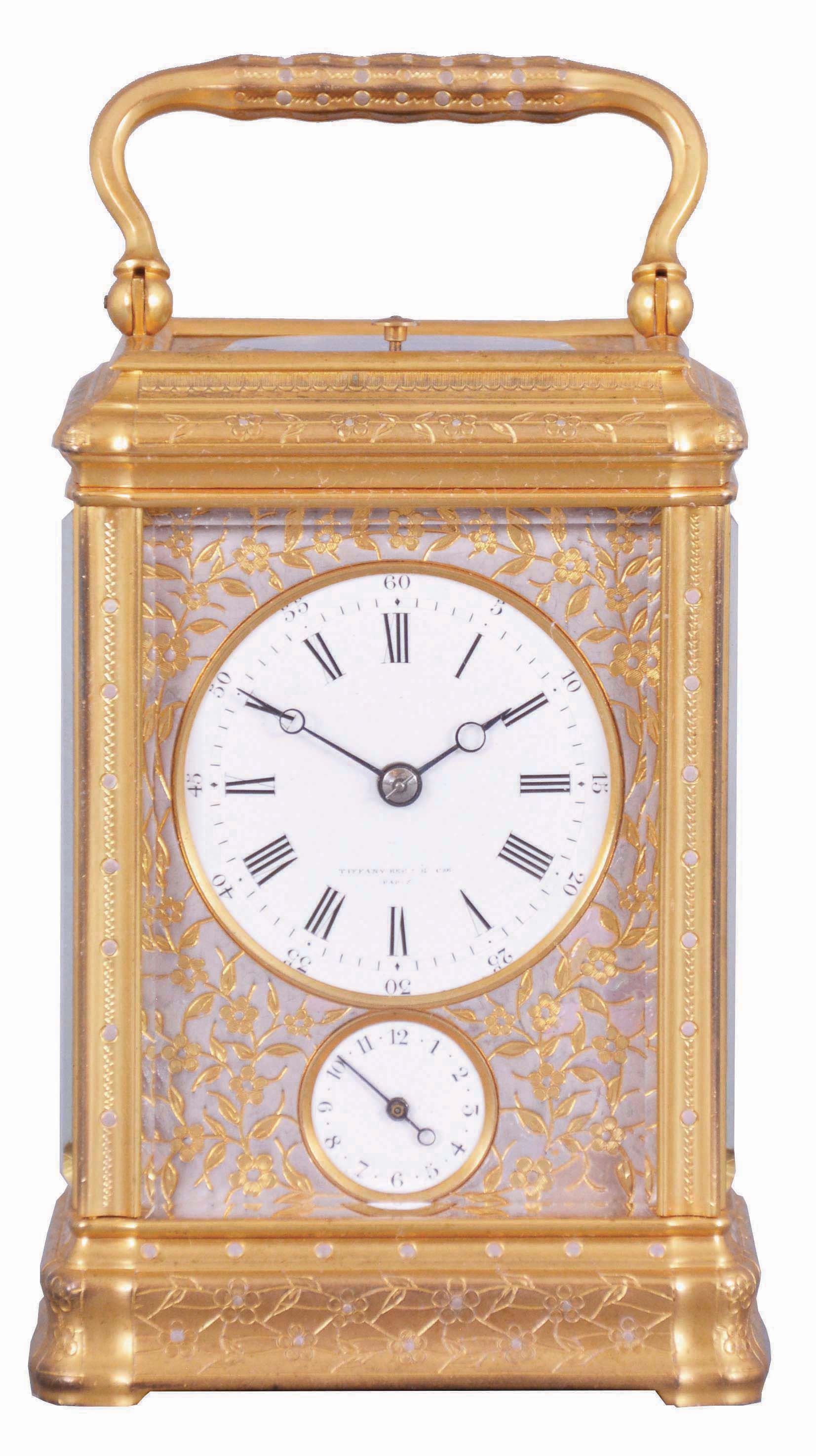Drocourt, for Tiffany, Reed &amp; Cie, Paris, a Gorge cased, hour repeating carriage clock with cold painted enamel ornament, gilt case with floral engraving and mauve accents, Roman numeral white enamel dial with engraved, gilt mask, also enhanced with mauve colored cold enamel, blued steel Breguet style hands, 8 day time, strike, and alarm movement with lever platform, repeating the last hour on demand, the back plate with the mark of Drocourt, serial #11150 — Antique Clocks Price Guide