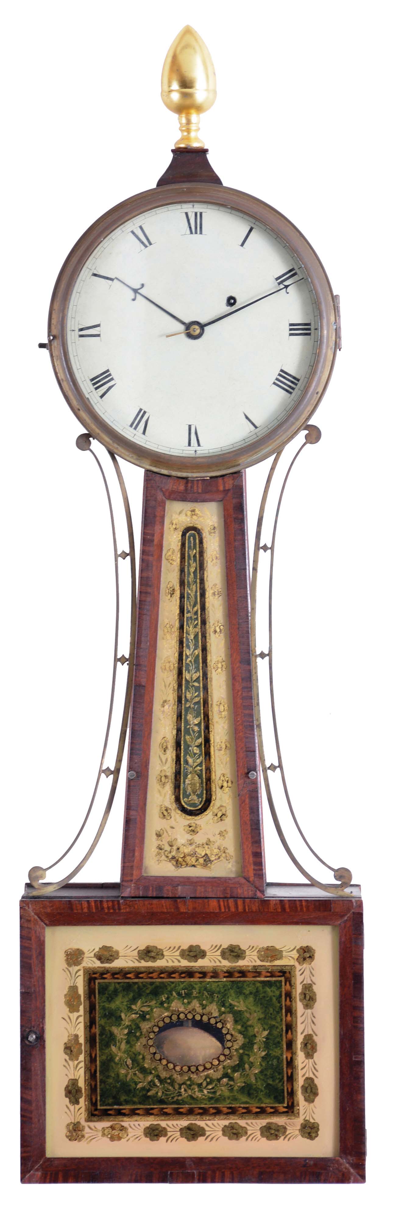 Attributed to Aaron Willard, Jr., Roxbury, Massachusetts, mahogany patent timepiece or "banjo" clock, iron roman numeral dial, brass bezel, side ornaments flanking the waist section, waist and box with cross banded frames for the reverse-painted glasses, the waist with gold floral and leafage decoration framing a central classical urn with climbing vine, the lower glass marked "Patent" within a centered rectangular panel with central aperture for pendulum viewing and leafage tied with a ribbon against a green ground, eight day timepiece movement with t bridge suspension, step train, and through bolts for case attachment, all powered by a period lead weight, regulated by a pendulum with steel rod and brass-faced bob, and period winding key. Provenance: J.T. Vogdes, Philadelphia as indicated by a printed label on the backboard of the case. — Antique Clocks Price Guide