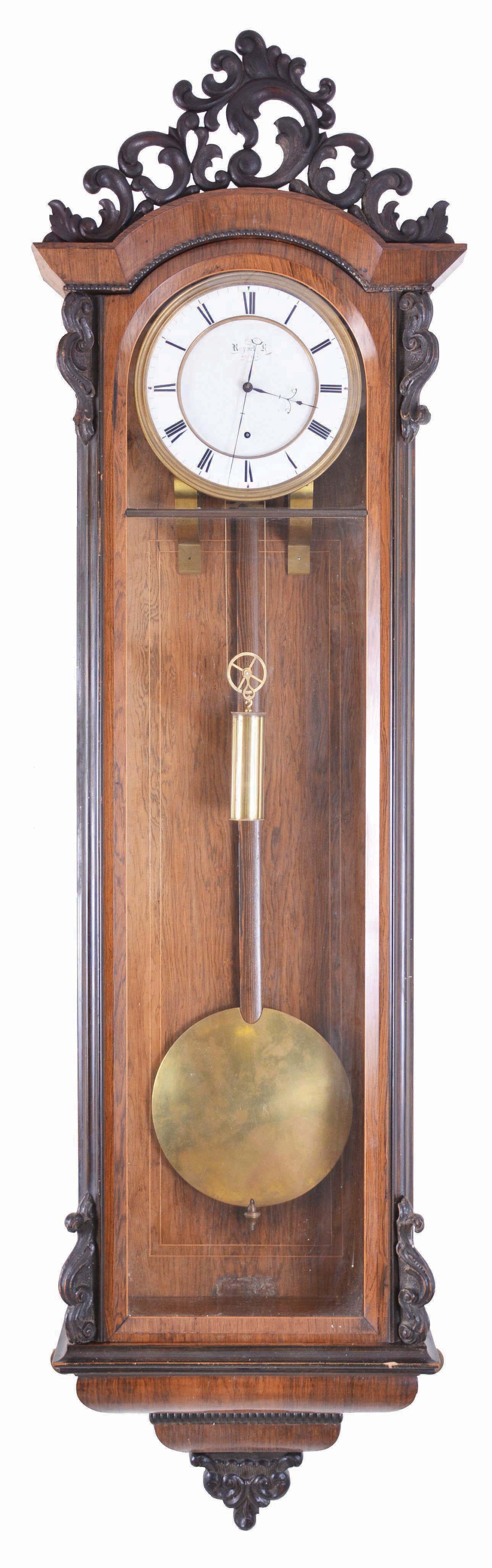 Rappel K, Budapest, large hanging Vienna regulator, 30 day, time only, brass, weight driven movement, rosewood veneer case with ebonized ripple molding and carved crest, door corners also with carved ornament, signed, Roman numeral white enamel dial with well made blued steel hands — Antique Clocks Price Guide