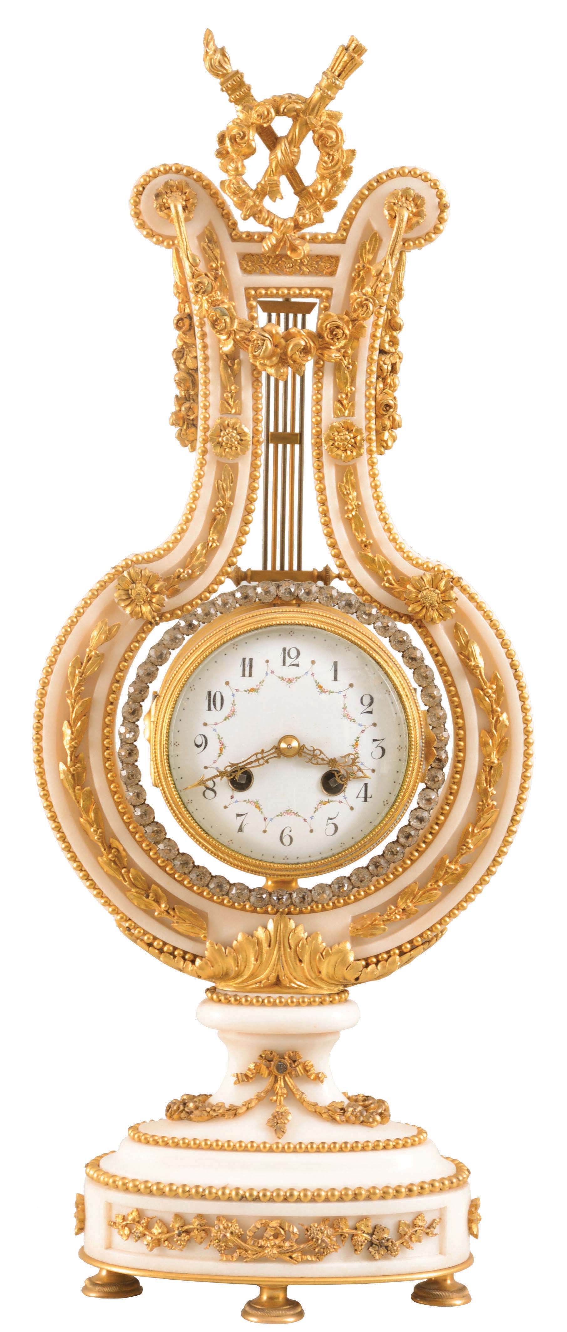 France, for Harris &amp; Harrington, New York, lyre form mantel clock, white marble case with gilt bronze mounts, including fruit and floral festoons, trailing vines and other foliate ornament, the top with rose wreath, torch and quiver, knife edge pendulum suspended behind the top ornament and with oscillating ring of brilliants, Arabic numeral white enamel dial with polychrome enamel garlands, ornate, gilt, pierced and engraved hands, 8 day, time and strike pendule de Paris movement, c1900 — Antique Clocks Price Guide
