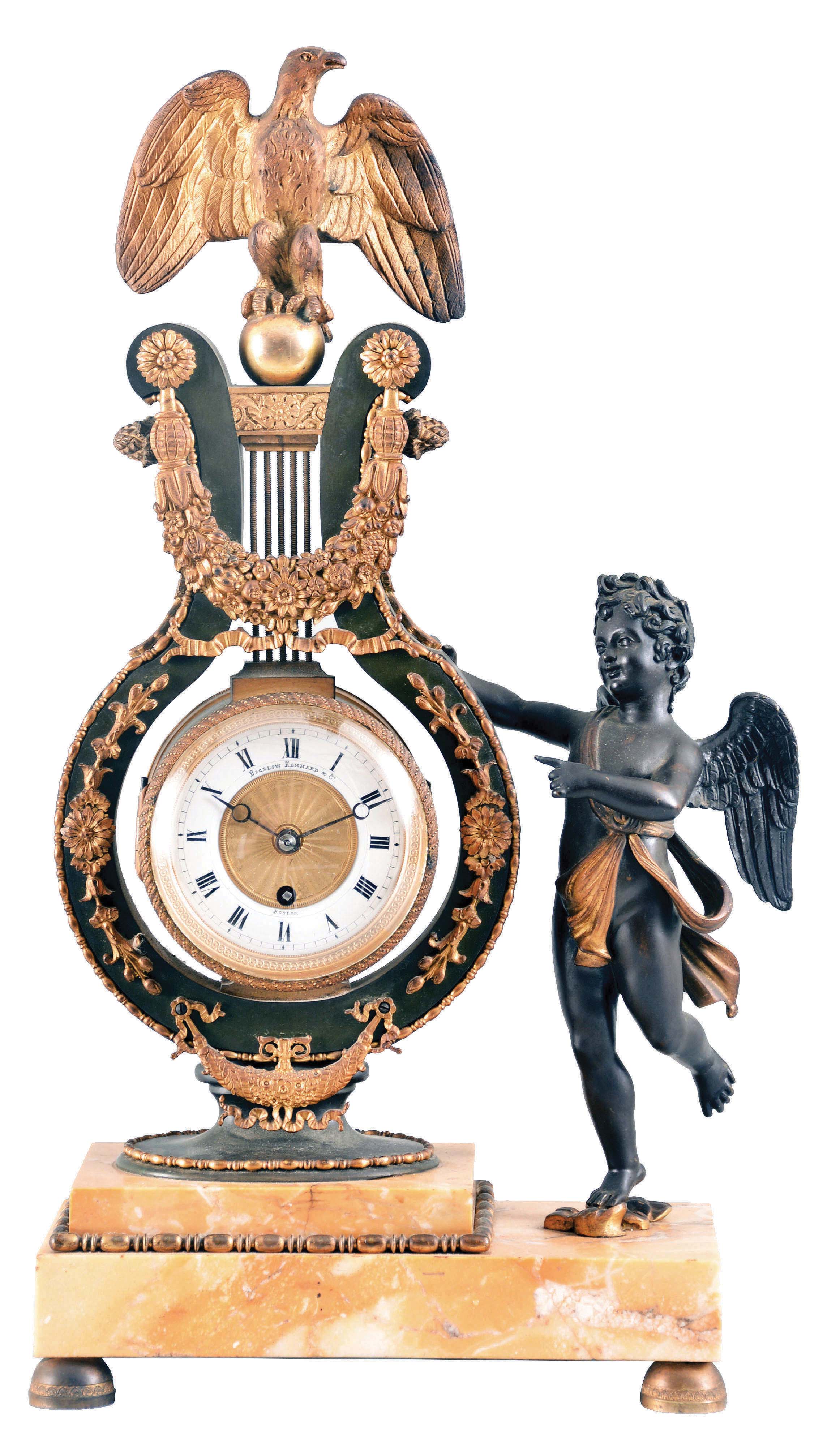 France, for Bigelow, Kennard &amp; Co., Boston, a sienna marble, gilt and patinated bronze mantel clock, the stepped stone base on gilt feet and supporting a patinated lyre form clock with gilt, naturalistic ornament, surmounted buy a gilt eagle finial, and with flanking, patinated putto gesturing toward the timepiece, Roman numeral white enamel dial with engine turned center, blued steel Breguet style hands, 8 day timepiece movement with lever platform and cut bimetallic balance — Antique Clocks Price Guide