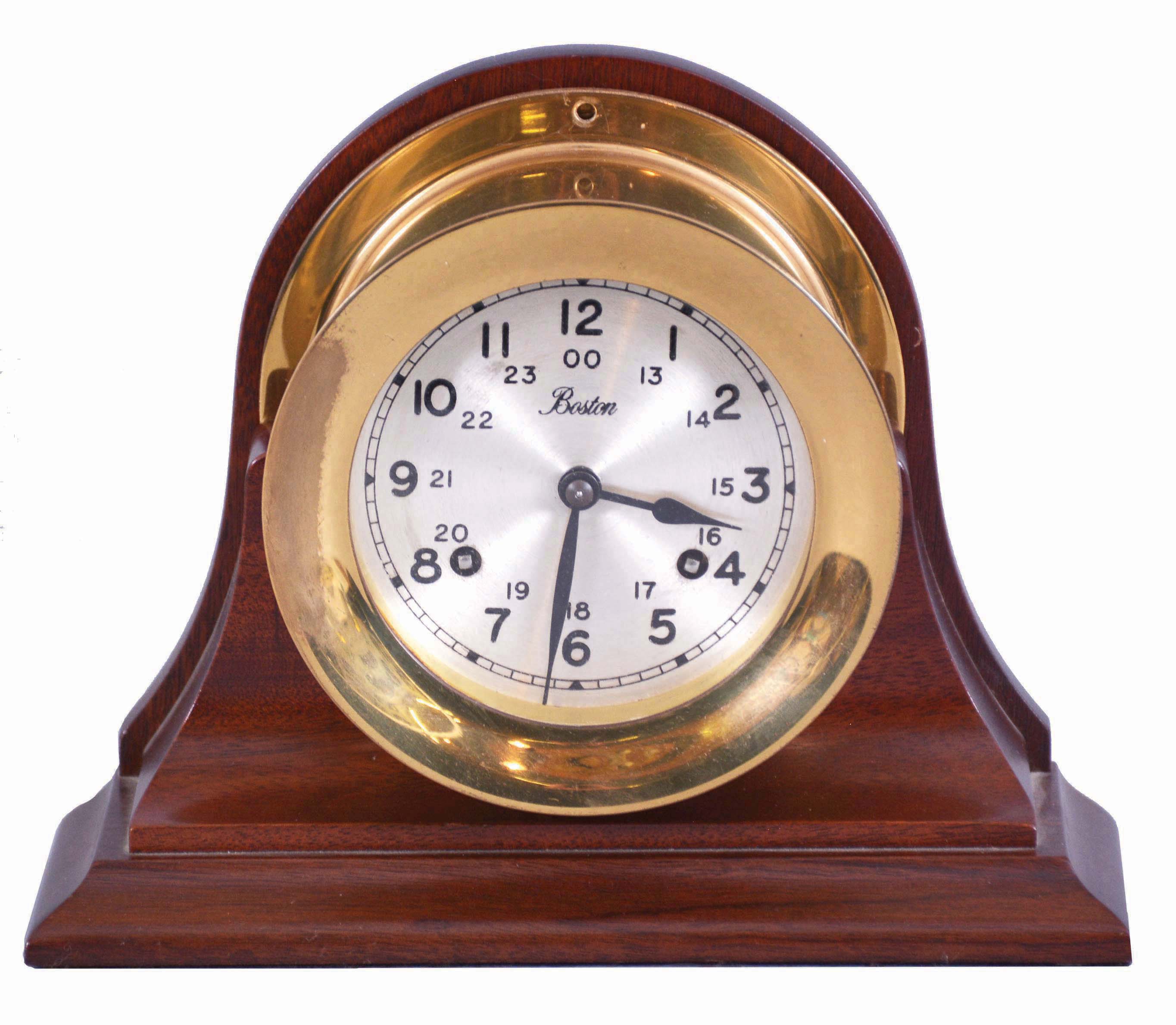 Boston by Chelsea Clock Co., Boston, Mass., marine clock, 8 day, time and strike, spring driven balance wheel movement in a polished brass case resting on the original mahogany cradle. — Antique Clocks Price Guide