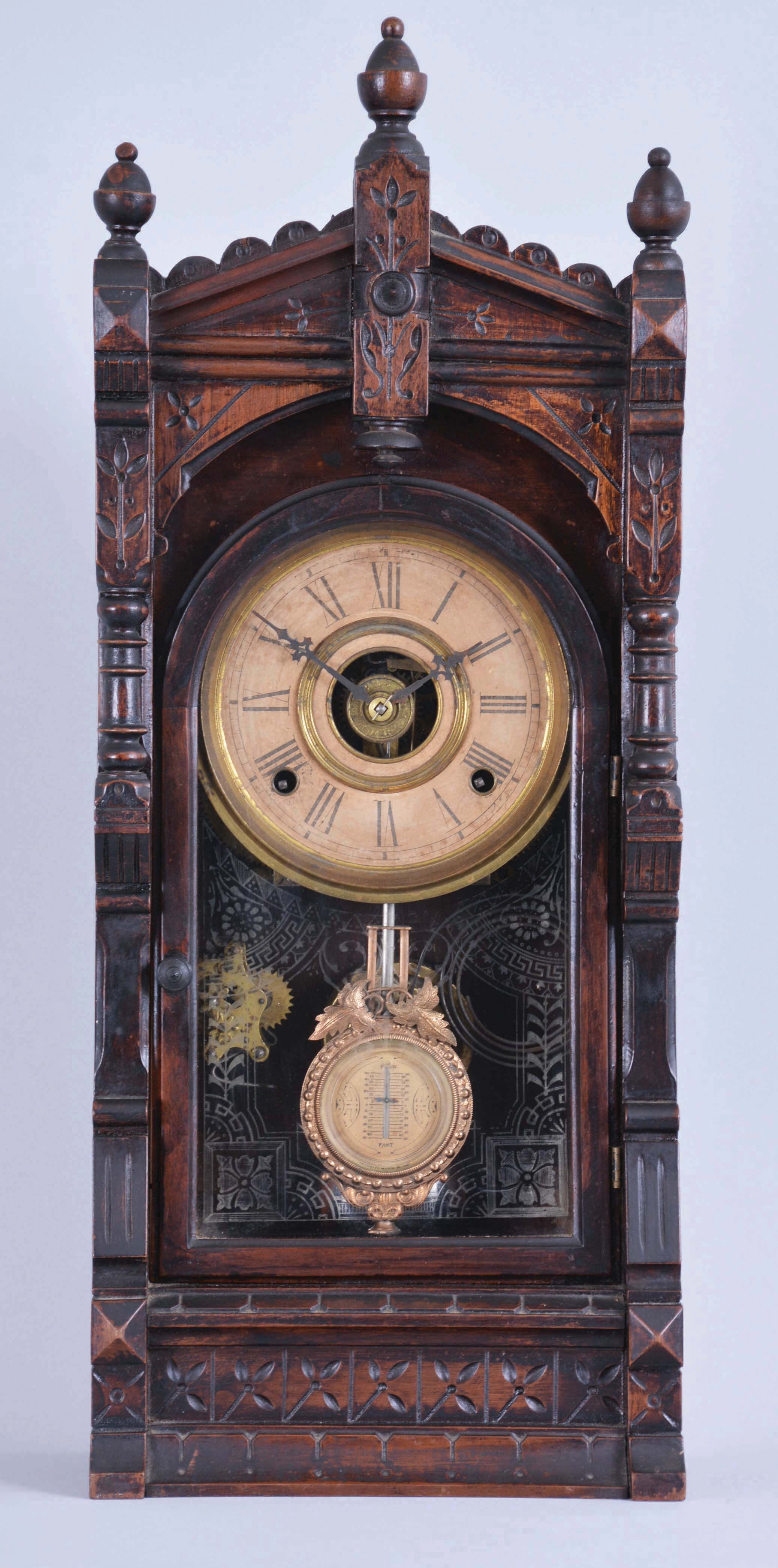 F. Kroeber Clock Co., New York, "Langtry" parlor clock, 8 day, time and strike with alarm, spring driven with walnut case, paper dial, and fancy regulating pendulum. — Antique Clocks Price Guide