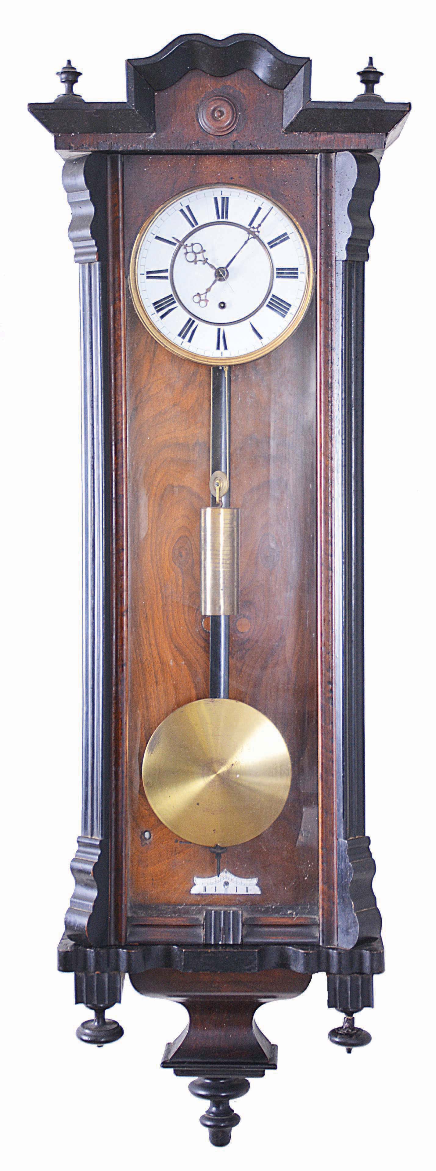 Clocks- 2 (Two) Gustav Becker Vienna Regulators: (1) Gustav Becker, Freiburg, Germany, one weight, 8 day Vienna regulator in a walnut veneer case with ebonized accents, white enamel dial with Roman numerals; (2) Gustav Becker, Freiburg, Germany, 3 weight quarter-striking, 8 day Vienna regulator in a walnut case with cast gilt metal ornaments, polychrome porcelain dial with embossed center, matching embossed brass weights and brass pendulum. — Antique Clocks Price Guide