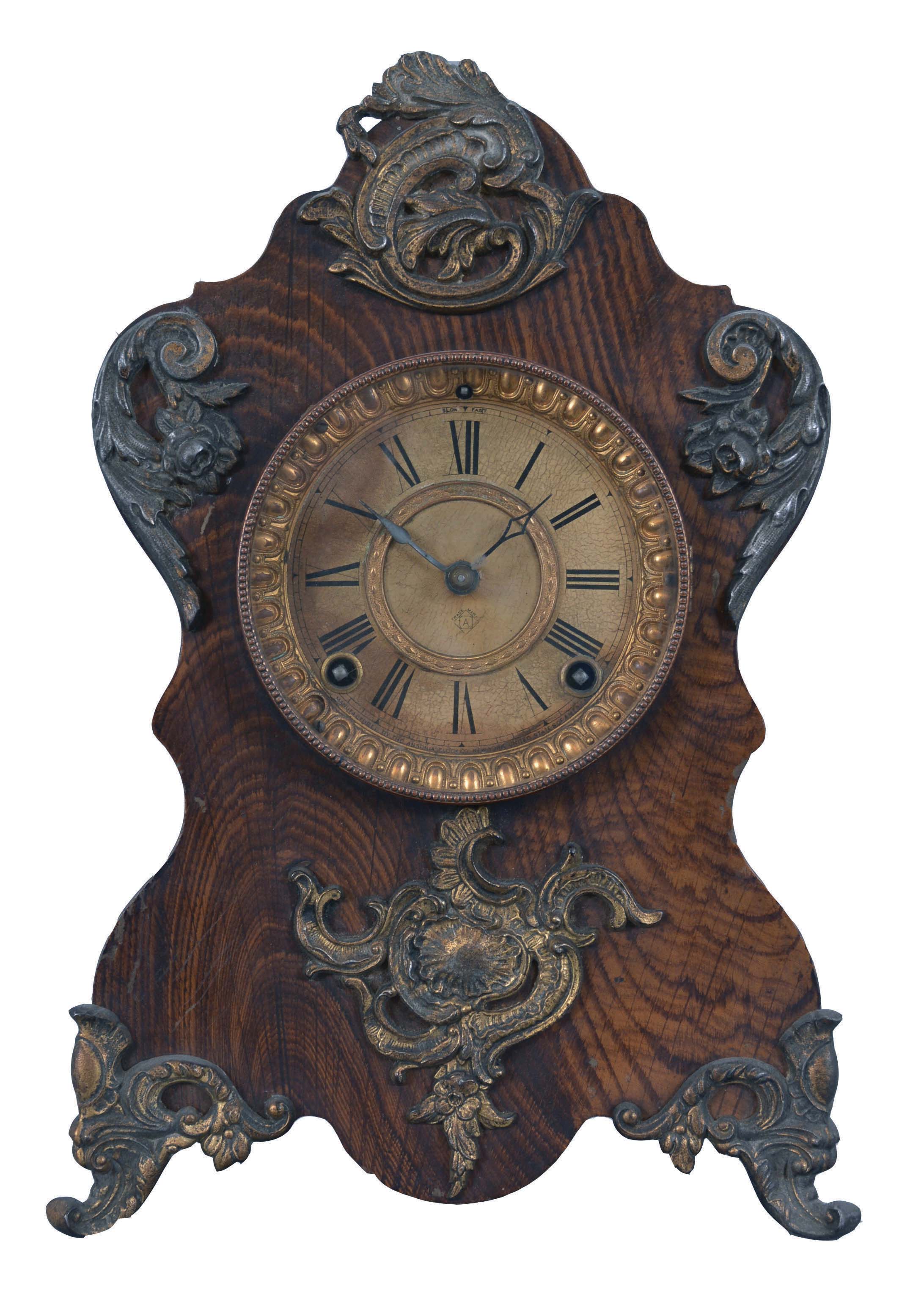 Clocks- 3 (Three) Shelf Clocks: (1) Probably Ketterer, Aron or Theodor, Furtwangen, Germany, 50 hour, time and strike, spring driven shelf cuckoo with inlayed veneer case and white enamel dial; (2) Germany, Junghans, "World Time" lighthouse clock, 8 day, time only, spring driven clock with 8 small dials for global times and local time showing on the larger dial in the base. A drive shaft extends upward from the movement to turn the armed wheel. Counterweights on the each of the 8 sets of motion works cause the time to advance on the small dials; (3) Ansonia Clock Co., New York, " Rouen" 8 day, time and strike, spring driven mantel clock in a grain painted iron case, c1894. — Antique Clocks Price Guide