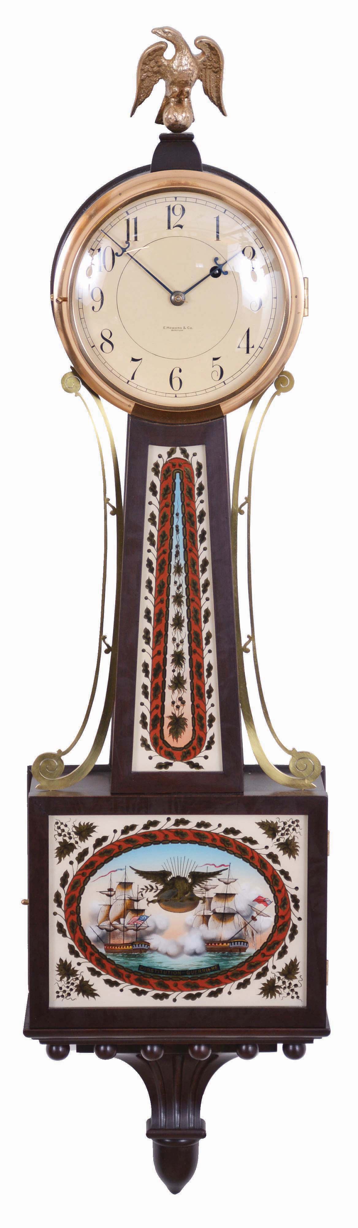 E. Howard &amp; Co., Boston, Mass, "No. 95 Banjo Clock", in mahogany case with eagle finial surmounting the Arabic numeral dial marked "E. Howard &amp; Co./Boston", brass bezel, flat frames for the reverse-paintings on glass, the lower depicting and marked "Constitution--Guerriere" in a blazing War of 1812 battle, a gilt patriotic eagle and banner tops the pendulum viewing port, all enclosed in a red, black and gilt oval cartouche with leafage surround and spandrels, the waist flanked with unusual brass side ornaments features repeating elements and colors set in an oblong border, the base carries a carved pedestal with acorn drop, eight day nickel plate movement marked "E. Howard &amp; Co./Boston" with recoil escapement and viewing ports, maintaining power, and Geneva stop all powered by a lead weight and regulated by a brass faced pendulum bob with flat wooden rod and tie-down. — Antique Clocks Price Guide