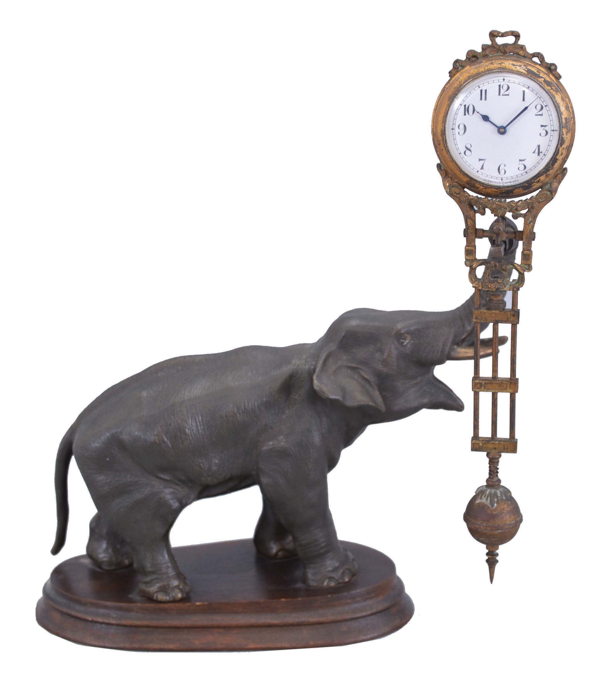 Germany, Junghans, elephant figure, swinging arm novelty clock, patinated figure on a molded wooden base, 8 day. — Antique Clocks Price Guide