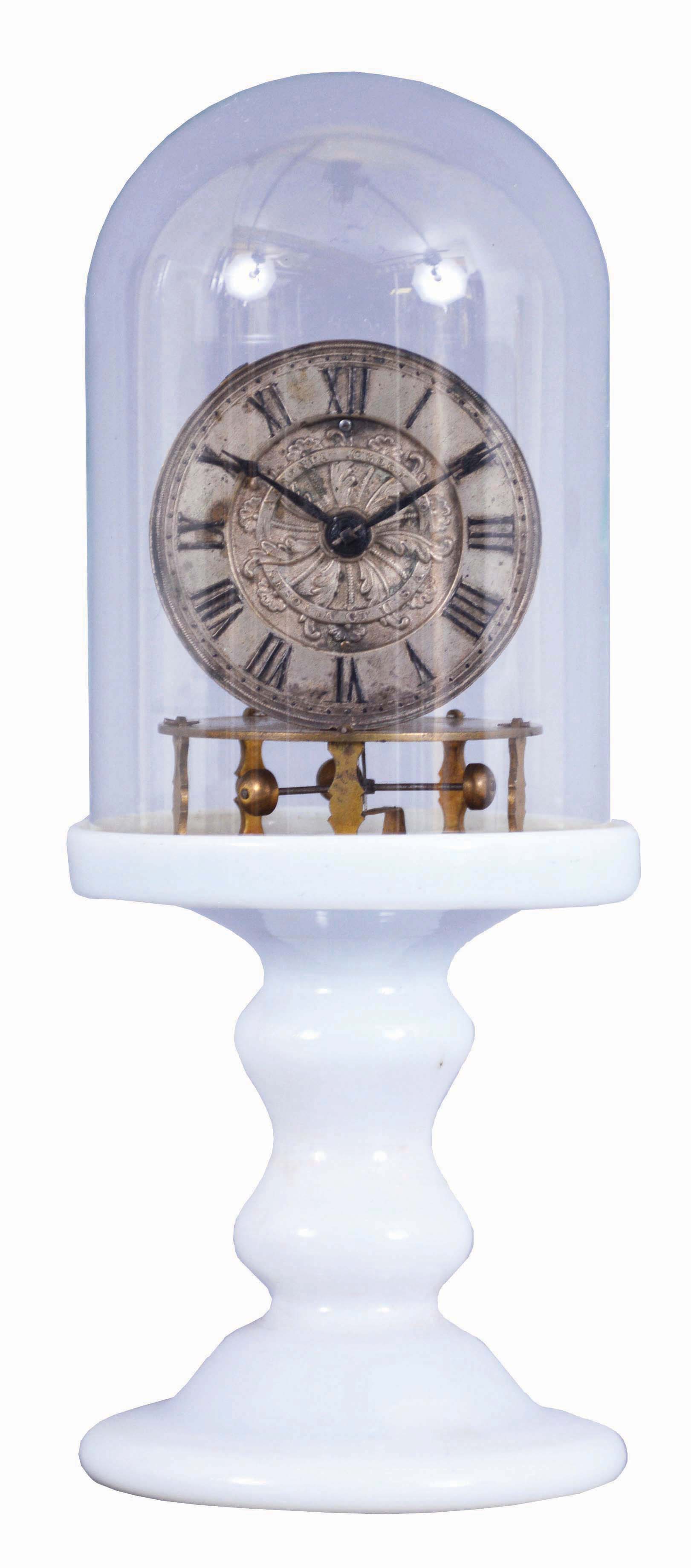Ansonia Clock Co., Ansonia, Conn., 3 arm balance, Torsion Candlestick Timepiece with 2 3/4-in. embossed &amp; silvered brass dial, thirty-hour timepiece with 3 small brass cups on the ends of the balance arms, hairspring, and regulator below the movement, back plate stamped Terry Ville Manufacturing Company, Terry Ville, Conn., Patented October 5th, 1852, milk glass pedestal and glass dome, — Antique Clocks Price Guide
