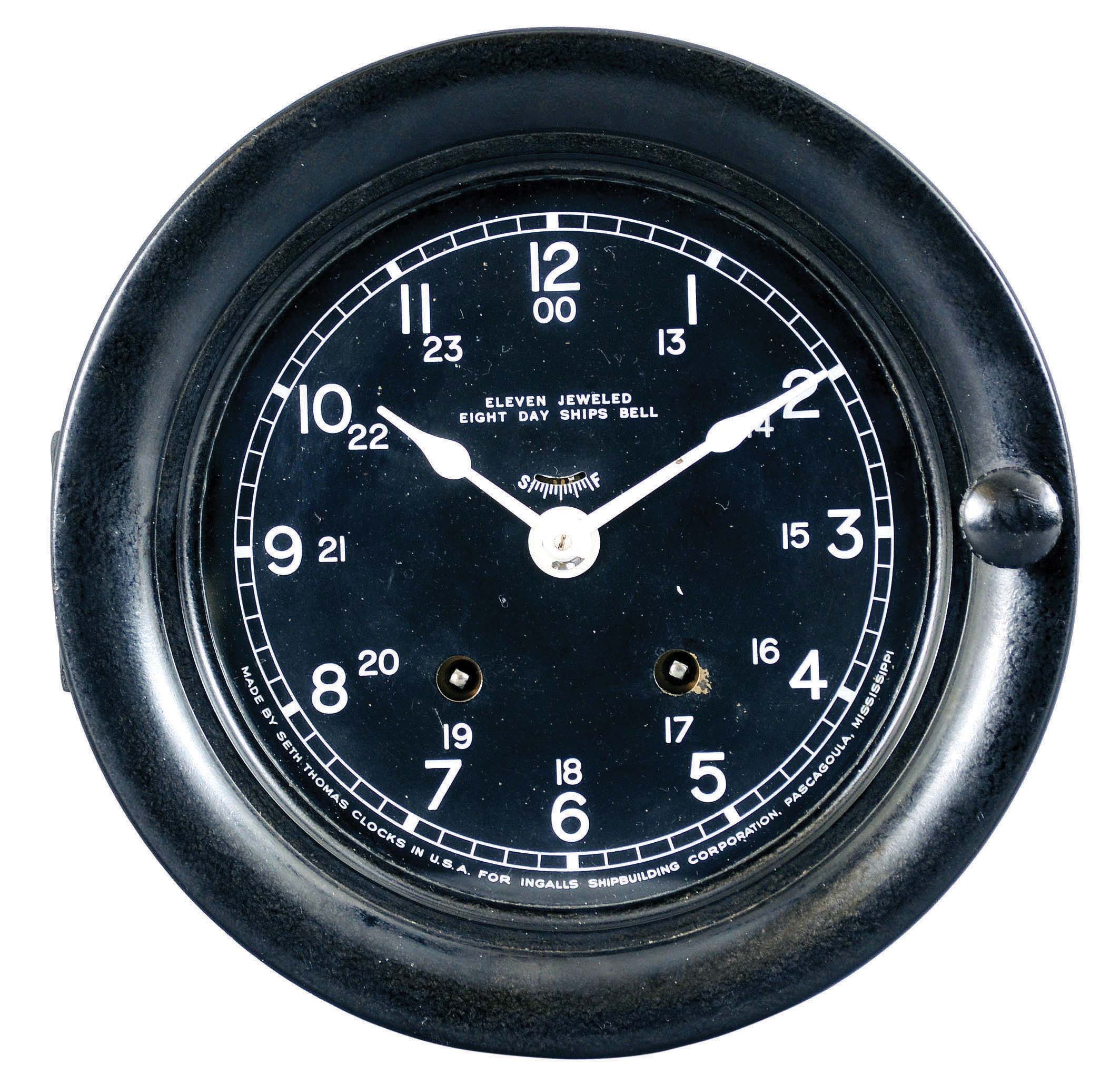 Seth Thomas Clock Co., Thomaston, Conn., for Ingalls Shipbuilding Corporation, Pascagoula, MS., ship's clock, 8 day, time and strike, spring driven 11 jewel movement in metal case with black wrinkle finish, hinged phenolic bezel, and 5 inch dial with white hands and numerals. — Antique Clocks Price Guide