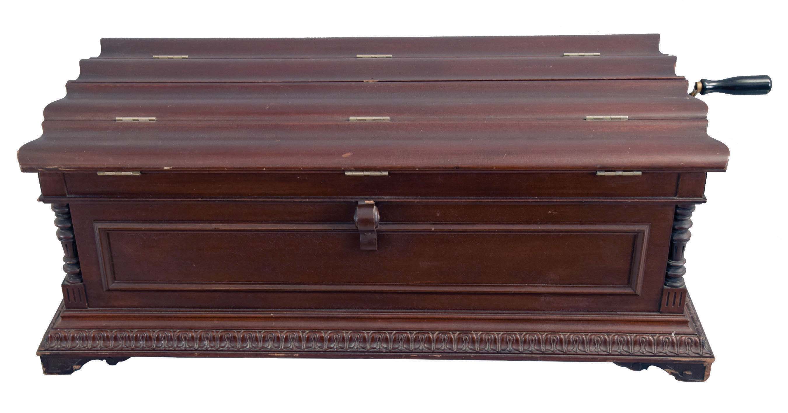 American, Regina Music Box Co., Style No. 6 Orchestral 27" Folding Top Table Model music box also sometimes called the "Casket Model". Mahogany case with applied carving and shaped bracket feet. Interior with original Regina Company celluloid label, the serial number stamped into the cast iron bedplate = 31207, and an 11" double comb mechanism, with removable crank. Includes 23 discs — Antique Clocks Price Guide