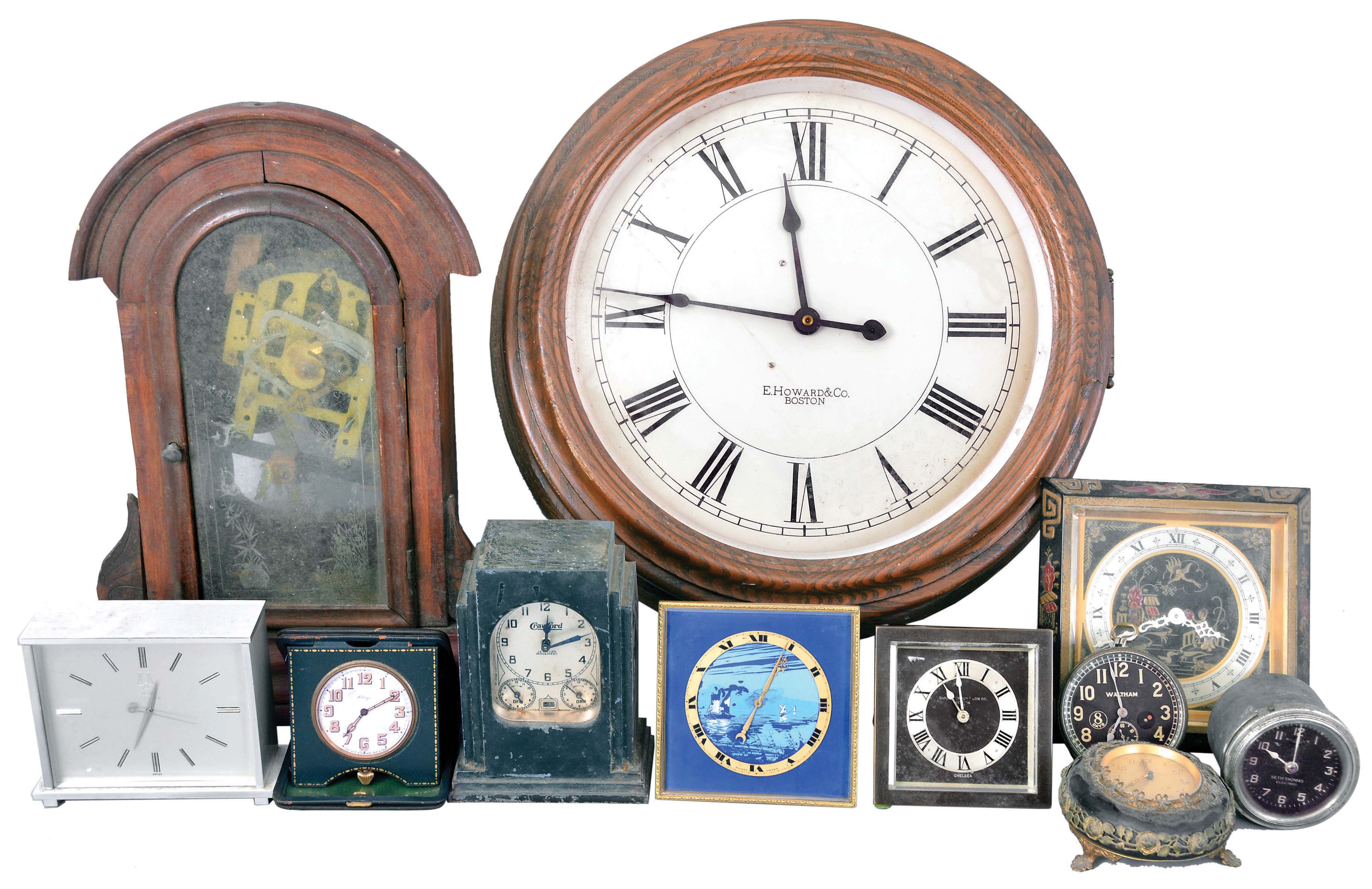 Clocks- 11 (Eleven) European and American Clocks: Lot includes 2 Chelsea easel clocks, one with the black "Chinese Lacquer" motif; Waltham 8 day clock clock; German made alarm clock; Lux "Automatic Range Timer"; Swiss-made 15 jewel travel clock; desk clock with Bulova Accutron movement; Swiss-made easel clock with blue dial; Seth Thomas electric car clock; mantel clock with Asian movement; E. Howard &amp; Co. gallery clock fitted with a battery movement. — Antique Clocks Price Guide