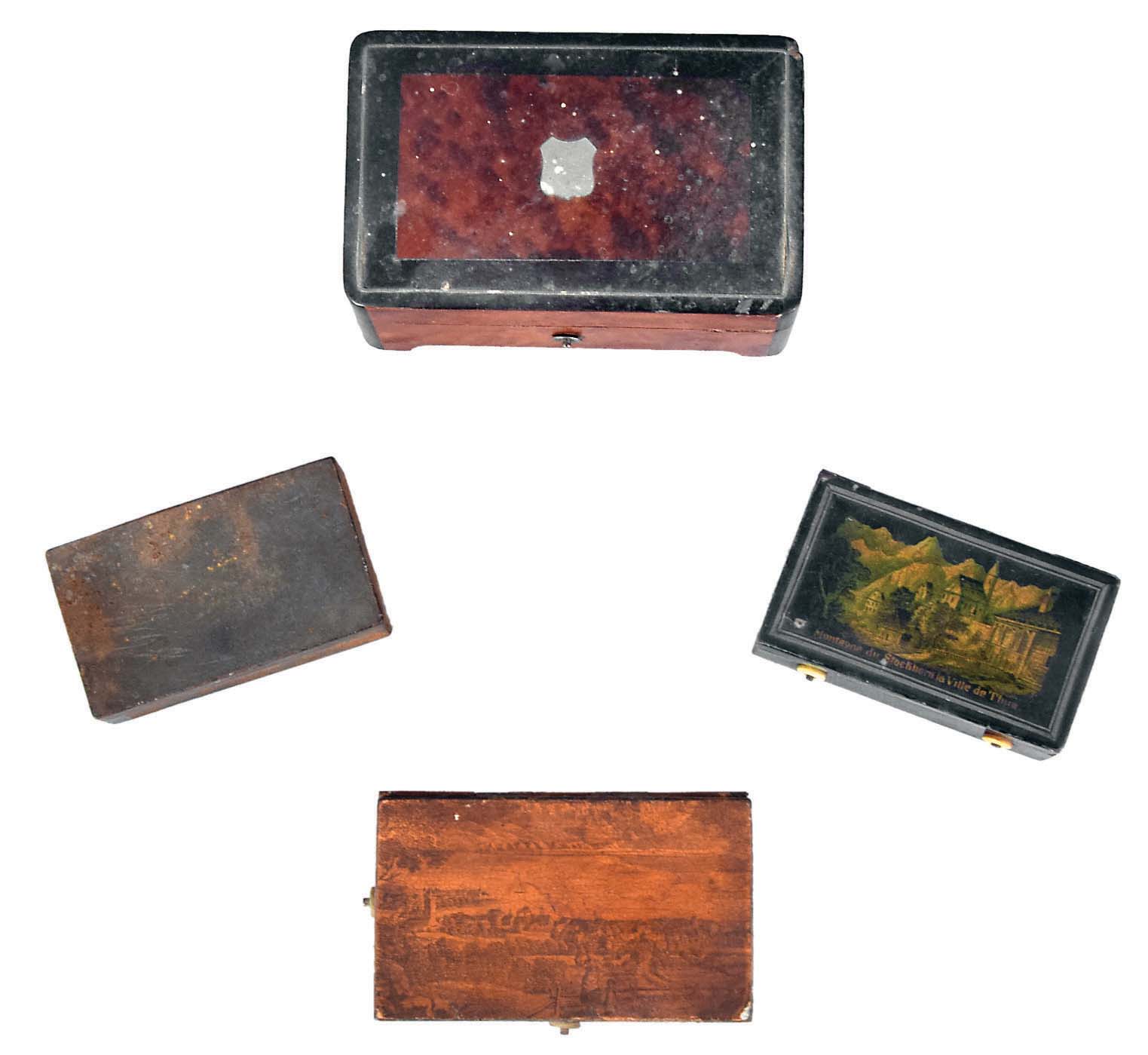 Music boxes- 4 (Four): Three with tin cases, two of those with transfer scenes decorating the covers, and one burl veneered box — Antique Clocks Price Guide