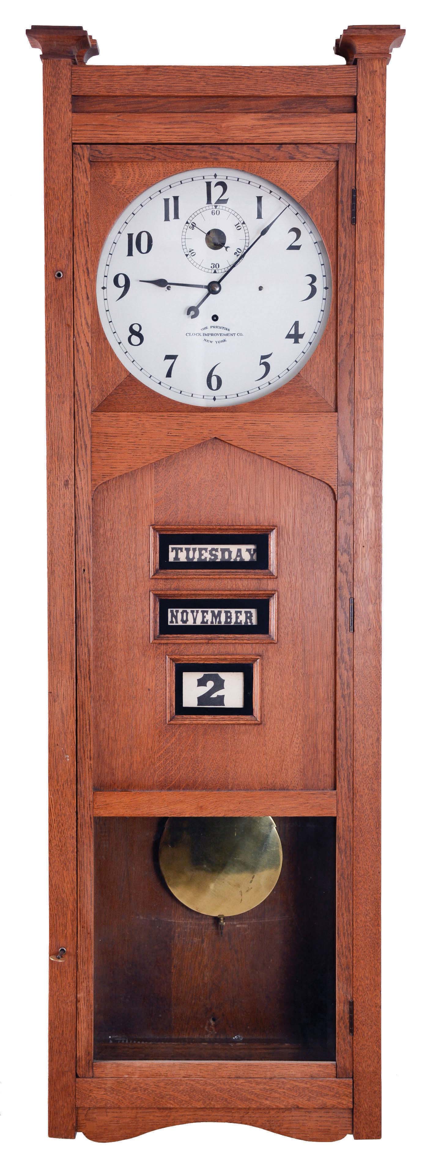 Prentiss Clock Improvement Co., New York, N.Y., large wall clock of 60 or 90 day duration, with time and perpetual calendar, double spring driven "No. 217" movement in an oak case with painted metal dial and with printed card stock calendar indicators — Antique Clocks Price Guide