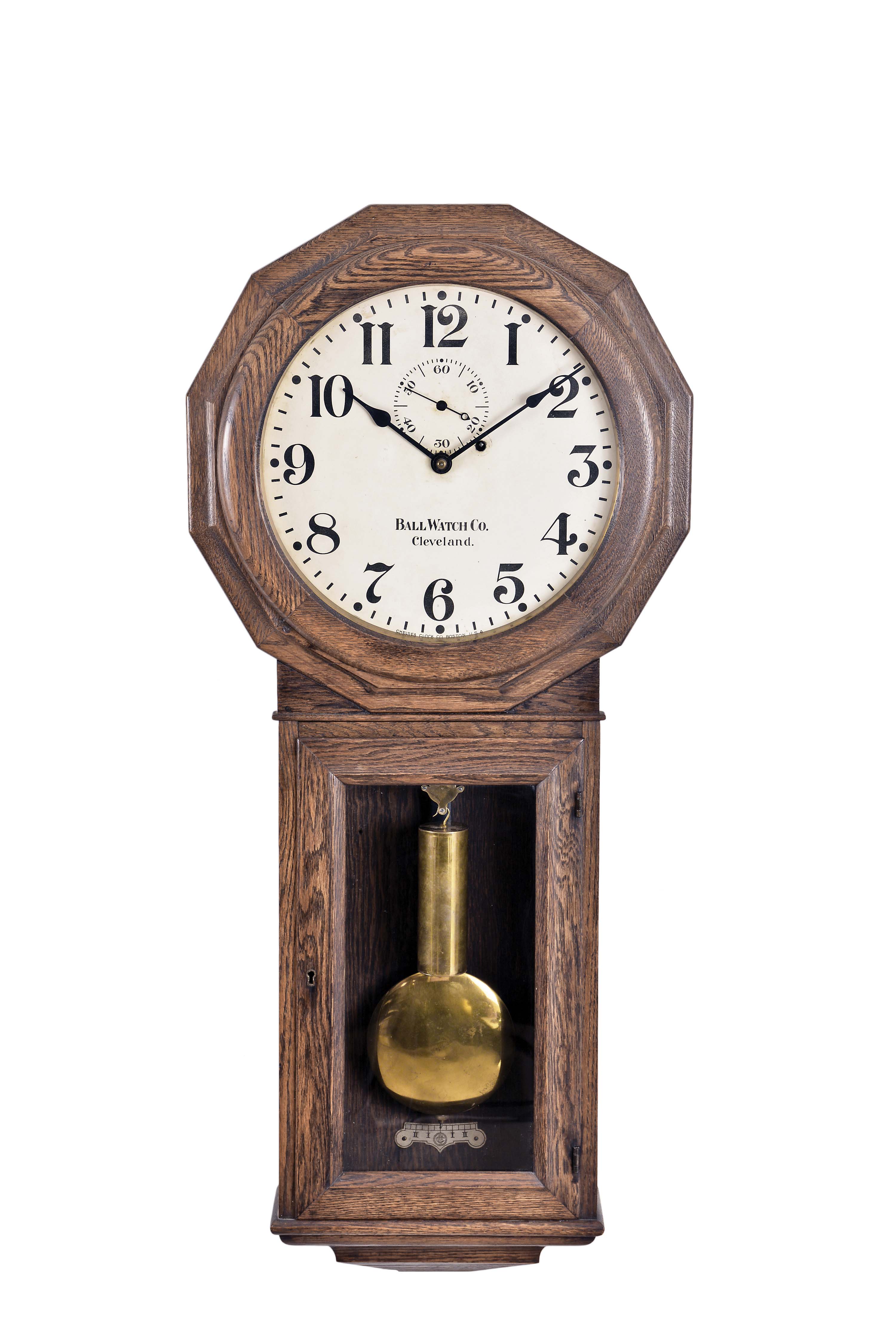 Chelsea Clock Co., Boston, Mass., "Model 2Q" hanging regulator for Ball Watch Company, Cleveland, Ohio, the oak No. 3 style case with octagonal top opening to the painted zinc arabic numeral dial, marked "Ball Watch Co./Cleveland.", and "Chelsea Clock Company/Boston U.S.A.", seconds bit and blued steel spade hands, with lower glazed door for pendulum and weight access, all on a molded pedestal, eight day brass trapezoidal plate movement marked "Chelsea Clock Company/Boston U.S. A.", dead-beat escapement with beat setting adjustment, maintaining power, movement and pendulum mounted to the iron bracket fastened to the back of the case, all powered by a compounded cylindrical brass weight and regulated by a flat wooden rod and brass pendulum, serial #176976 — Antique Clocks Price Guide